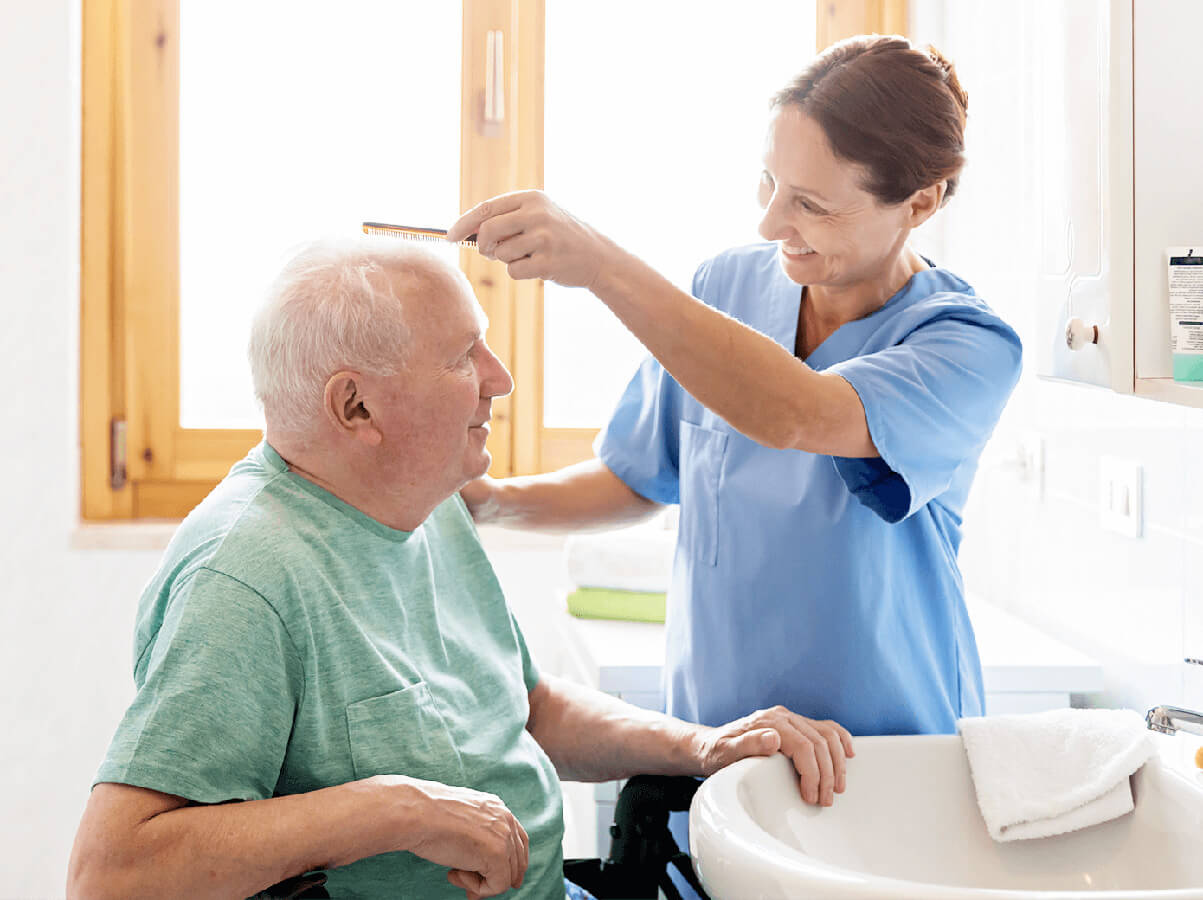 caregiver combing mans hair caregiver combing mans hair